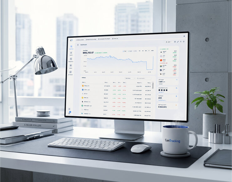 CoinTracking dashboard on a desktop monitor in a modern office overlooking the city